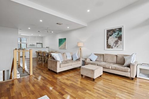 a living room with two couches and a table at South Shores Villa 12 in Normanville