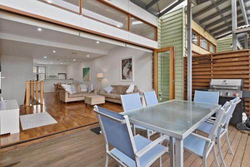 a dining room and living room with a table and chairs at South Shores Villa 12 in Normanville
