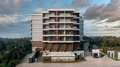 a tall white building with a sign on it at Gateway Goa, Palolem in Palolem