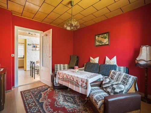 a living room with red walls and a couch at Countryside Stay in Meisdorf in Meisdorf