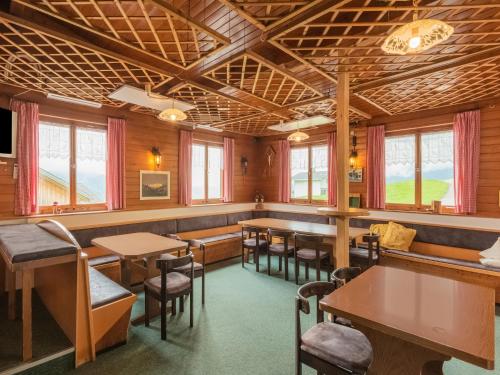 a restaurant with tables and chairs and windows at Chalet in Schwarzenberg am Skilift in Schwarzenberg
