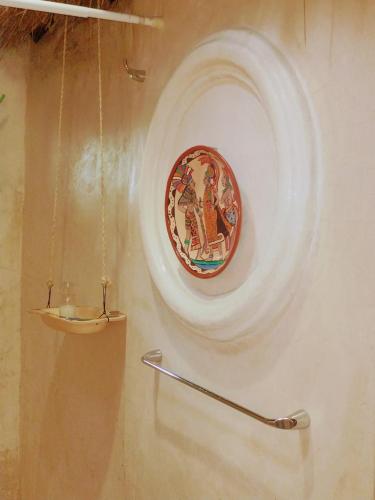 a plate hanging on a wall with a shelf at Hotel y Museo Aldea Maya Toktli Orígenes - Casa Maya Del Toloque Coronado - Alberca, Wifi Starlink, Tour Museo in Izamal