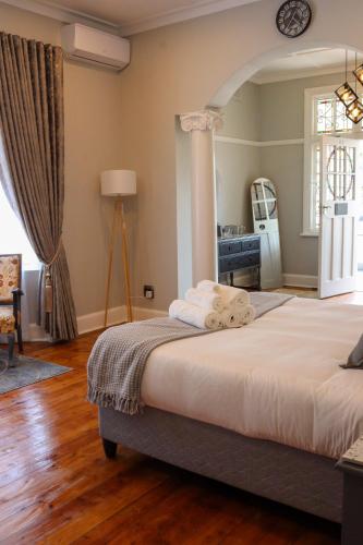 a bedroom with a large bed and a dresser at The Essenwood Collection in Durban