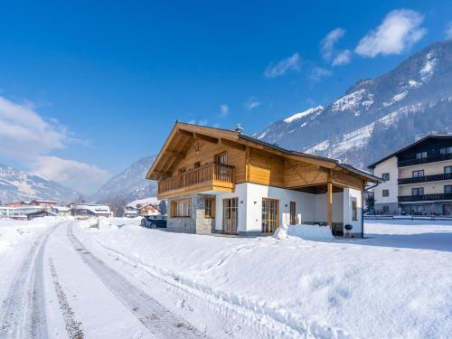 a house in the snow with mountains in the background at Chalet in Bad Hofgastein near Ski Slopes in Bad Hofgastein