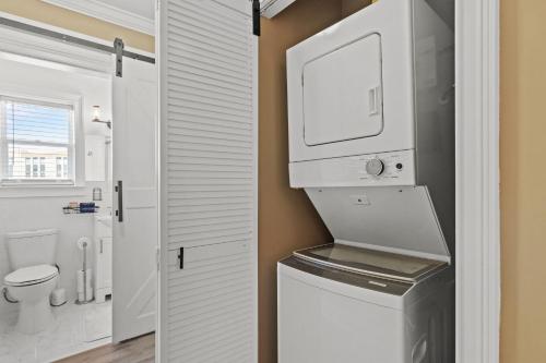 a white bathroom with a sink and a refrigerator at Historic Downtown Waterfront Access Near Beach in Panama City Beach