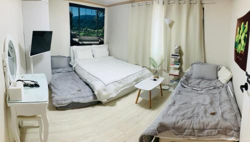a small bedroom with a bed and a chair at 1 min from Sadang Station line 2 & 4 in Seoul