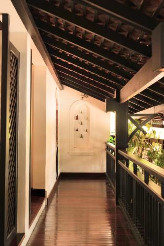 a walkway leading to the front door of a house at La Résidence Phou Vao in Luang Prabang