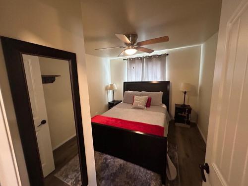 a bedroom with a bed and a ceiling fan at Authentic Remodeled Taber Street Railroad House in Williams