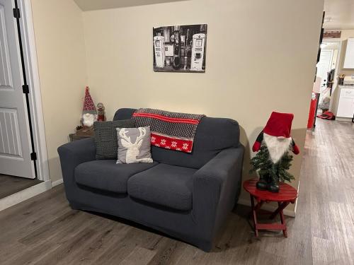 a gray couch with a santa hat on a table at Authentic Remodeled Taber Street Railroad House in Williams