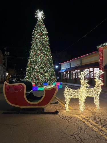 a christmas tree and reindeer in front of a store at Authentic Remodeled Taber Street Railroad House in Williams