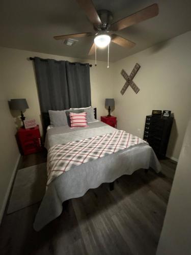 a bedroom with a bed and a ceiling fan at Authentic Remodeled Taber Street Railroad House in Williams