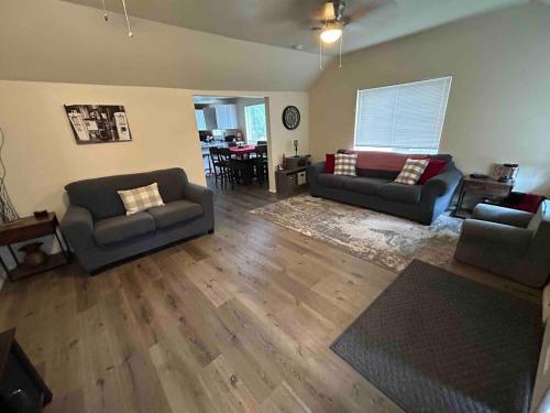 a living room with two couches and a table at Authentic Remodeled Taber Street Railroad House in Williams