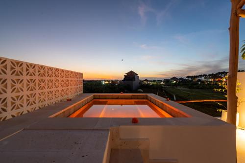 a view of the sunset from the roof of a house at Villa Romance in Tumbak Bayuh