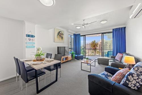 a living room with a couch and a table at Alexandra on the Pacific in Mooloolaba