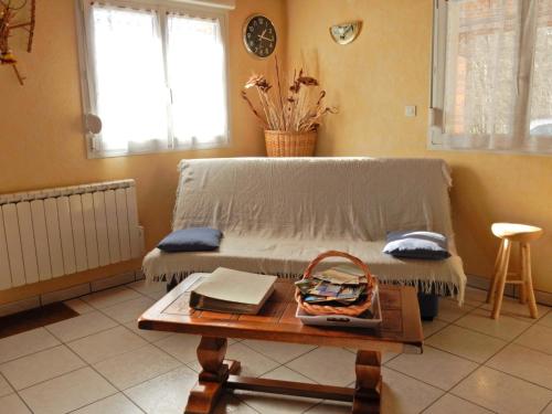 a living room with a couch and a table at Holiday Home in Vosges with Garden and BBQ in Le Haut-du-Them