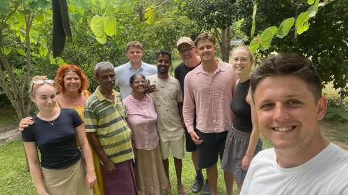 a group of people posing for a picture at Forest Tree Top Holiday Resort in Buttala