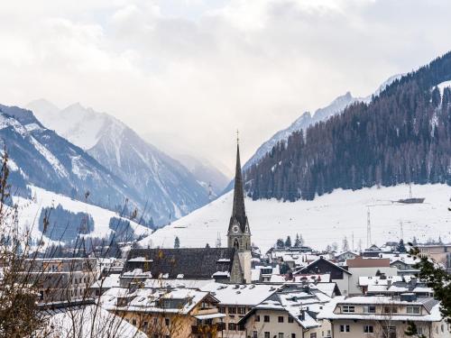 a small town with a church in the snow at Chalet in Bruck near Ski Slopes in Bruck an der Großglocknerstraße
