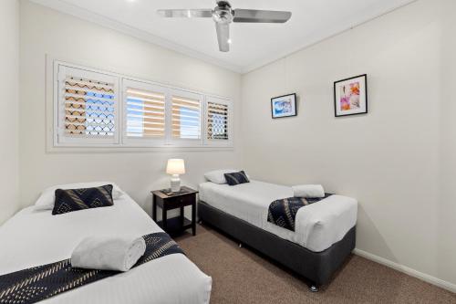 a bedroom with two beds and a window at Alexandra on the Pacific in Mooloolaba