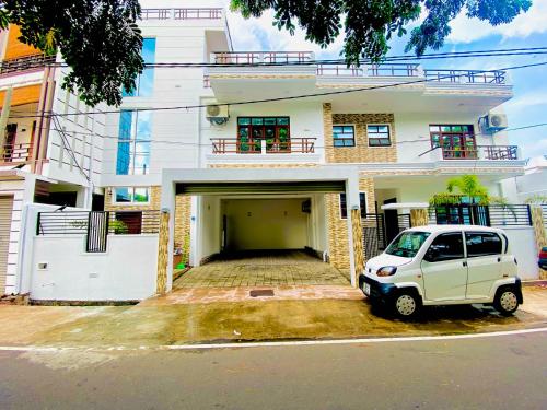a white car parked in front of a building at Dutch Villa - Trincomalee in Trincomalee