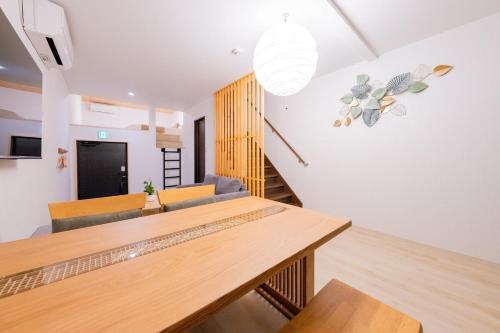 a dining room with a table and chairs at 光 和風お風呂を楽しむお宿 usjまで電車で1分 駐車場付き ベッド6台 寝室3つ バスルーム2台 in Osaka
