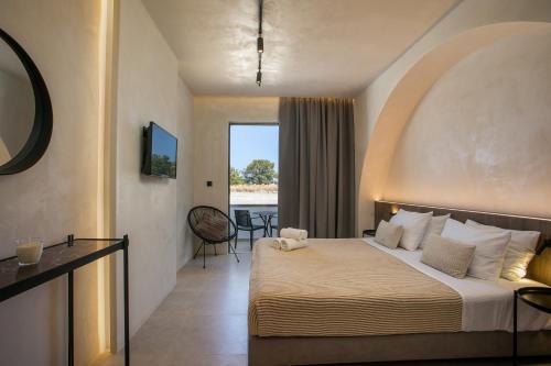 a hotel room with a bed and a view of the ocean at Ano Kampos Hotel in Faliraki