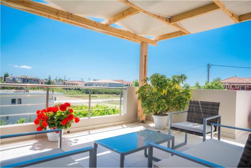 a balcony with a table and chairs and a view at Tesys Studios and Apartments in Laganas