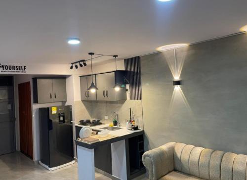 a living room with a couch and a kitchen at apartamento en barranquilla in Puerto Colombia