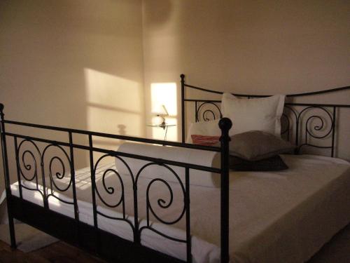 a bedroom with a bed with white sheets and pillows at Ferienhaus in Waren an der Müritz in Waren