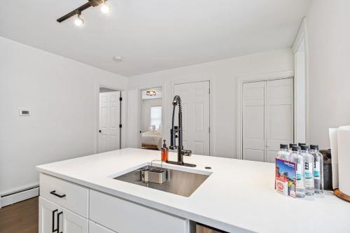a kitchen with white cabinets and a sink at Federal HILL PRIDE 1 - Ground-Floor Flat in Providence
