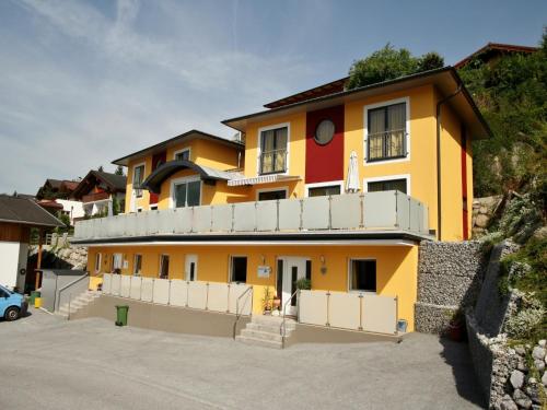 a yellow house with a fence in front of it at Chalet in Fürth near Zell am See Ski Slopes in Piesendorf
