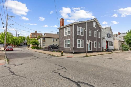 an empty street with a gray house and a fire hydrant at Federal Hill PRIDE in Providence