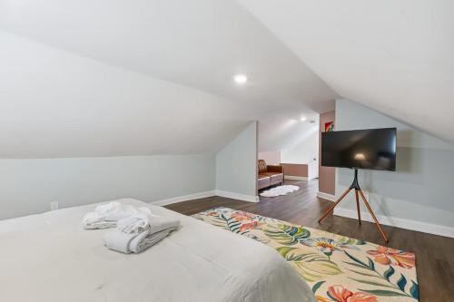 a bedroom with a bed and a flat screen tv at Federal Hill PRIDE in Providence