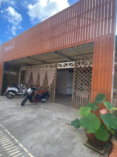 a motor scooter parked in front of a building at Bless You Hostel in Pai