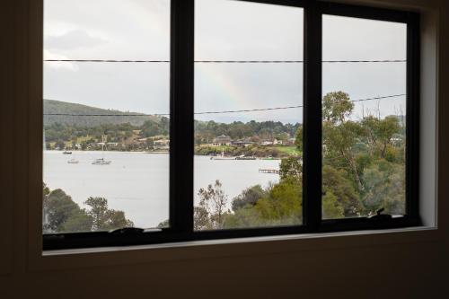 a window with a view of a body of water at Bay View Retreats- Ocean mist in Dover