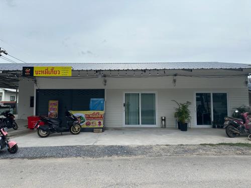 a gas station with motorcycles parked outside of it at 1-bedroom Modern Cozy near Samui Airport in Ko Samui