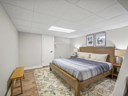 a bedroom with a bed and a table in it at Bloomfield, Pittsburgh Large and Accessible 3 Bedroom Apr with Free Parking in Pittsburgh