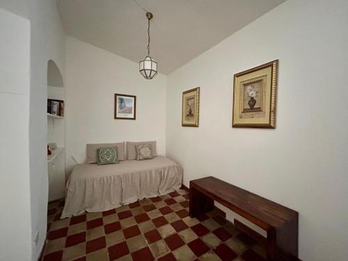 a bedroom with a bed with a checkered floor at Matteotti 45 in Sarzana