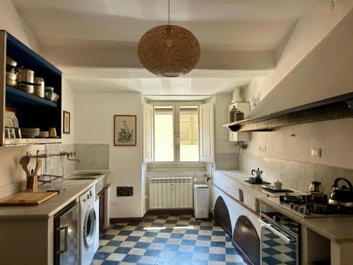 a kitchen with a blue and white checkered floor at Matteotti 45 in Sarzana
