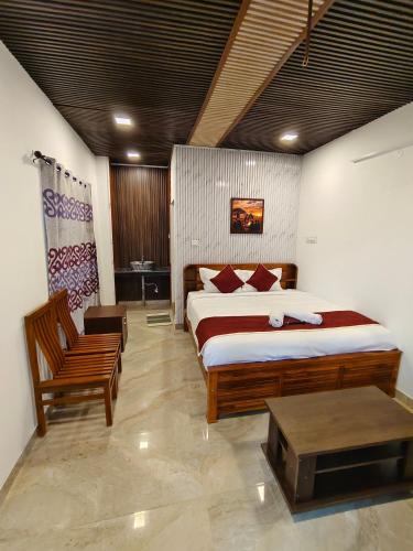 a bedroom with a large bed and a chair at Luxury Heaven Valley in Kodaikānāl