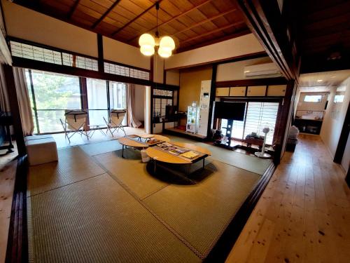 a living room with a couch and a table at ゲストハウスKoToKoTo in Makurazaki