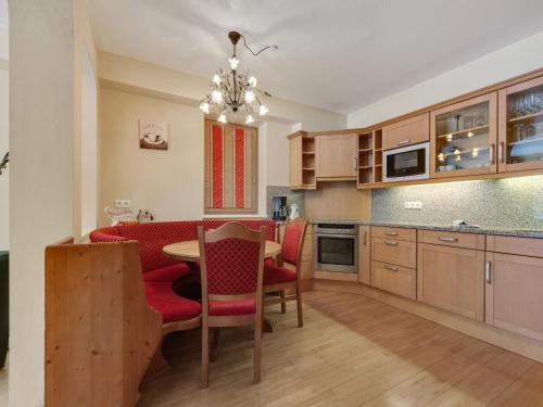 a kitchen with a table and chairs and a dining room at Chalet in Saalbach near Ski Lift in Saalbach Hinterglemm