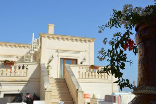 a white building with stairs in front of it at Agriturismo I Pozzetti in Savelletri di Fasano
