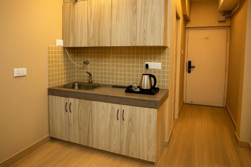 a kitchen with a sink and a counter top at Skystay Lucknow in Lucknow