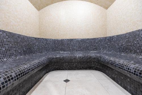 a room with black and white tiles on the wall at Spa Hotel Persenk in Devin