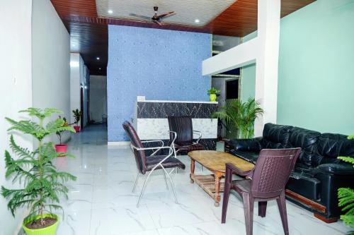 a living room with a table and chairs and a couch at Banaras Bloom Residency in Varanasi