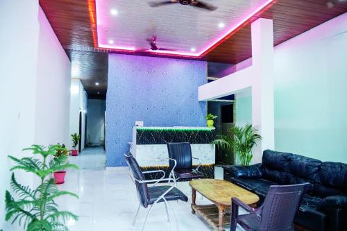 a living room with a couch and a table and chairs at Banaras Bloom Residency in Varanasi