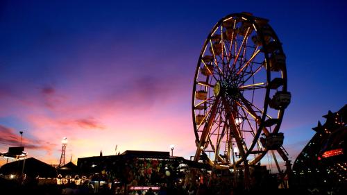a ferris wheel at a carnival at sunset at Holiday Inn & Suites Bakersfield by IHG in Bakersfield