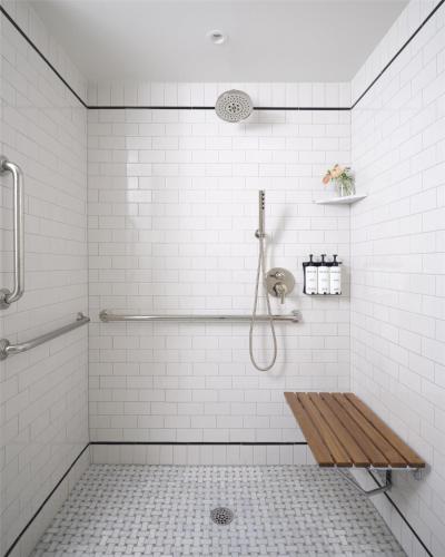 a shower with a wooden bench in a bathroom at The Bellevue Hotel, in the Unbound Collection by Hyatt in Philadelphia