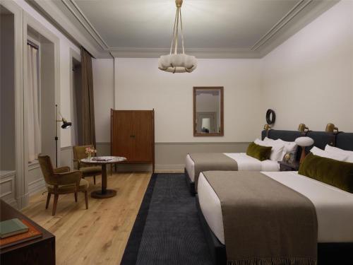a hotel room with two beds and a couch at The Bellevue Hotel, in the Unbound Collection by Hyatt in Philadelphia