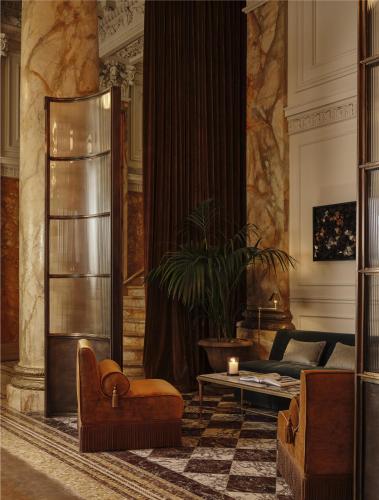 a living room with a couch and a table at The Bellevue Hotel, in the Unbound Collection by Hyatt in Philadelphia